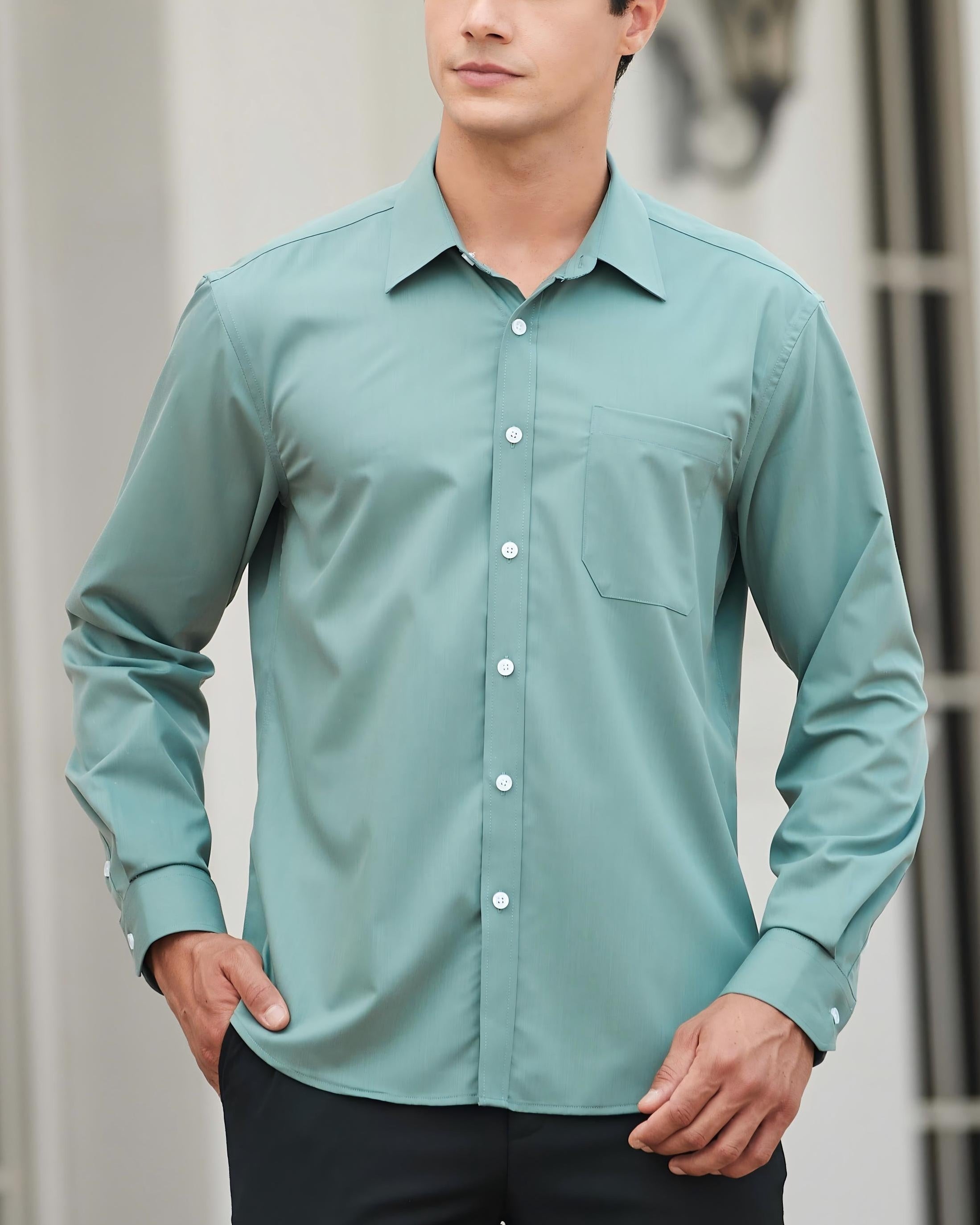 Man wearing a light blue shirt with a blurred background
